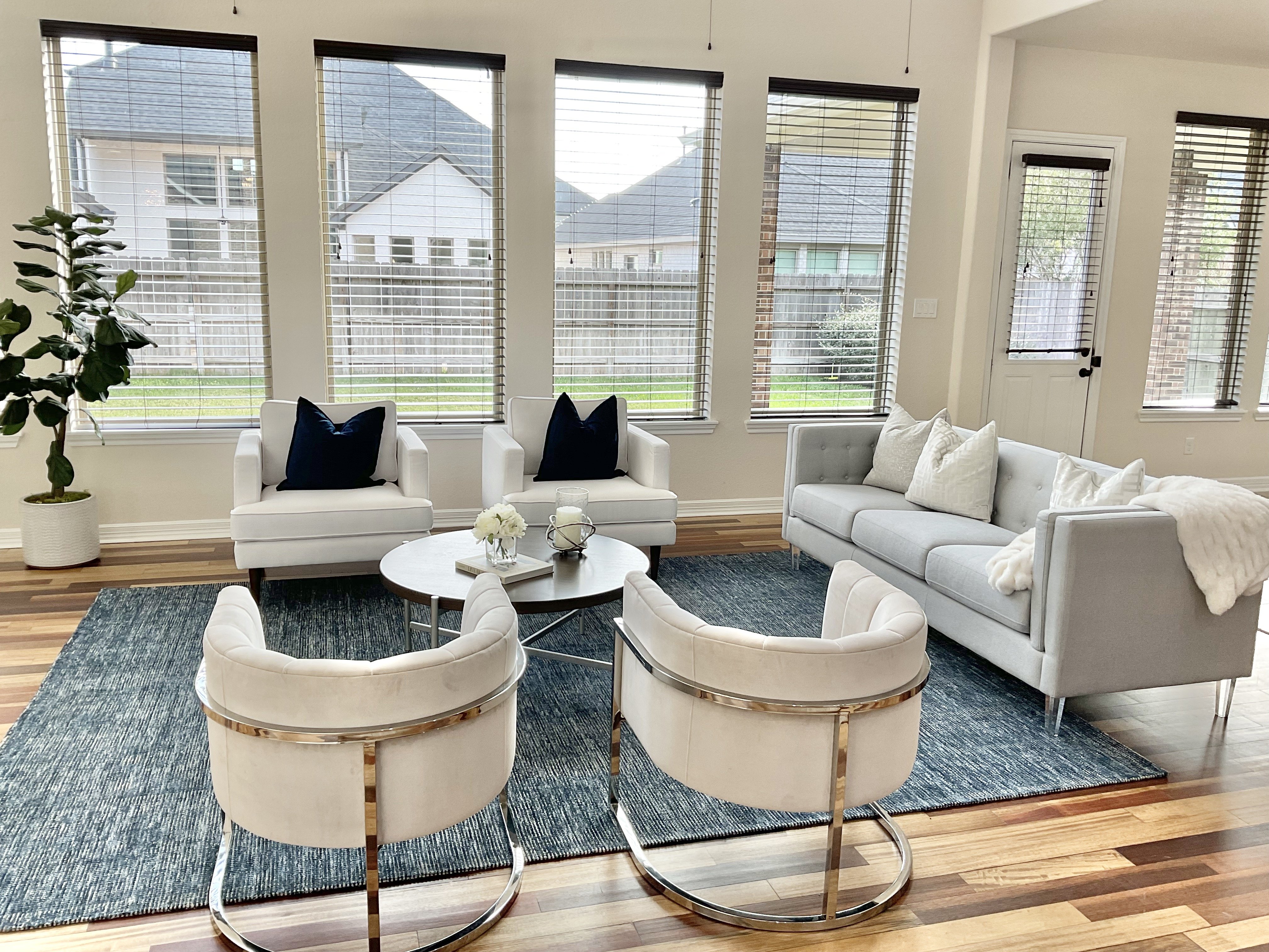 Living room with four chairs and blue rug