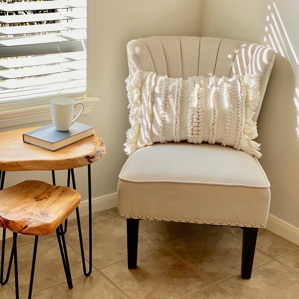Sitting area with living edge side table, and white chair.