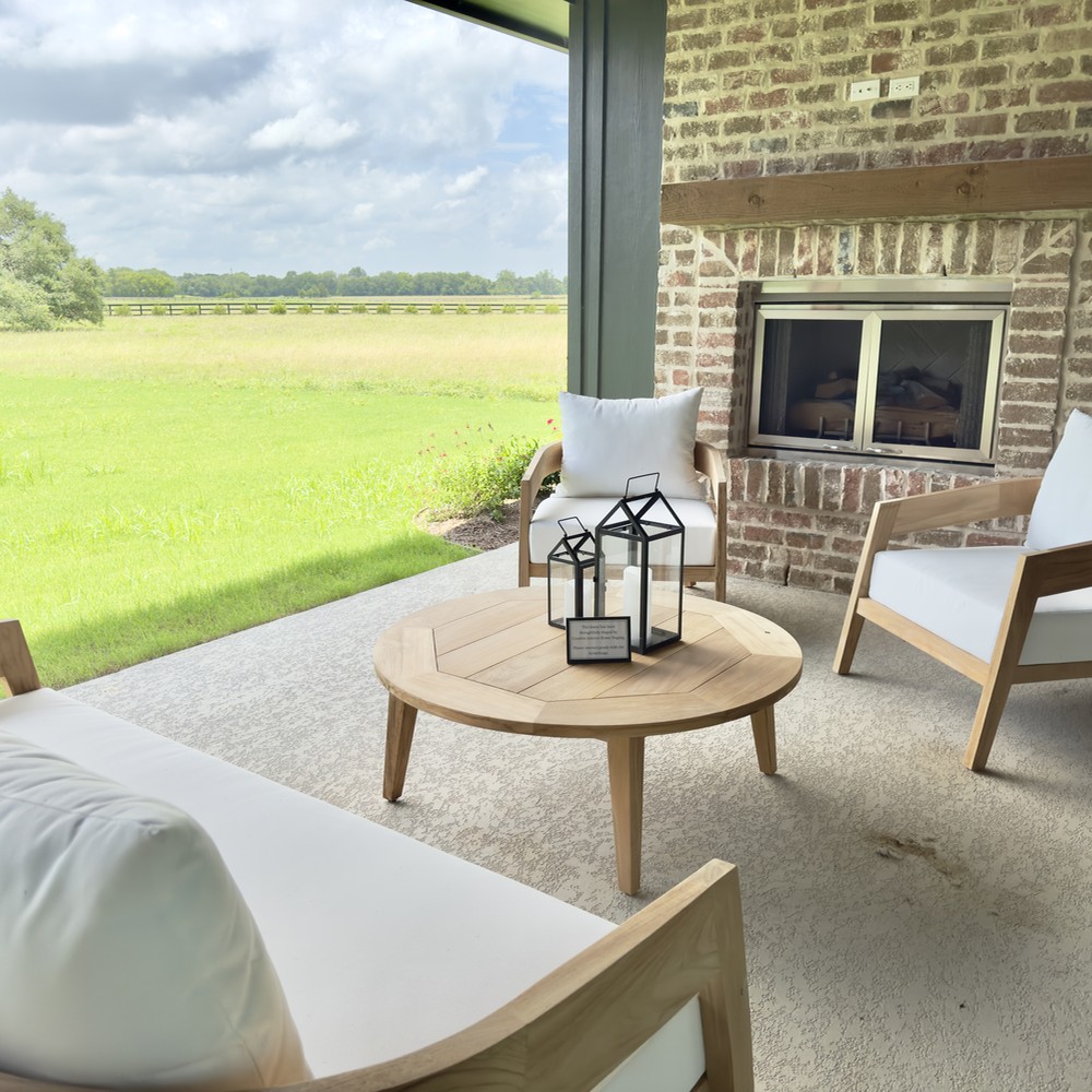 Round Top, TX Home Staging Patio with wooden furniture and white upholstery.