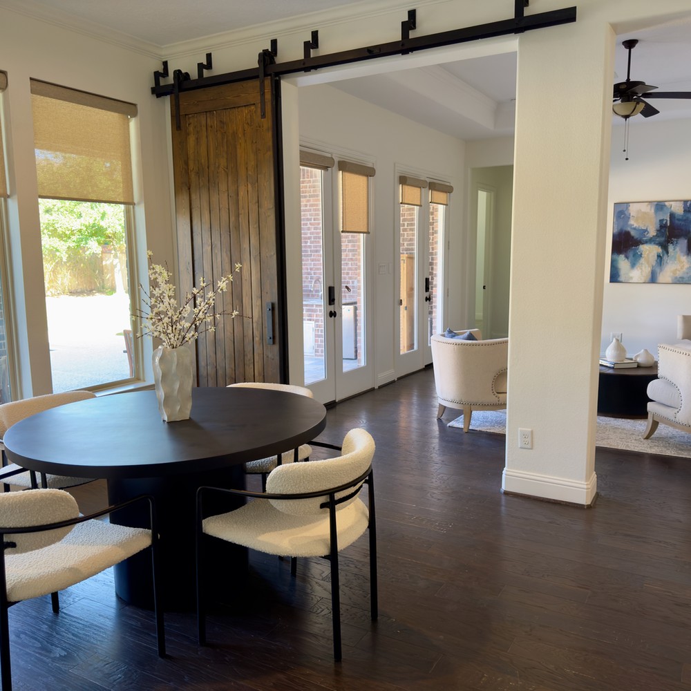 The Woodlands Vacant Home Staging: Black breakfast table with white chairs.