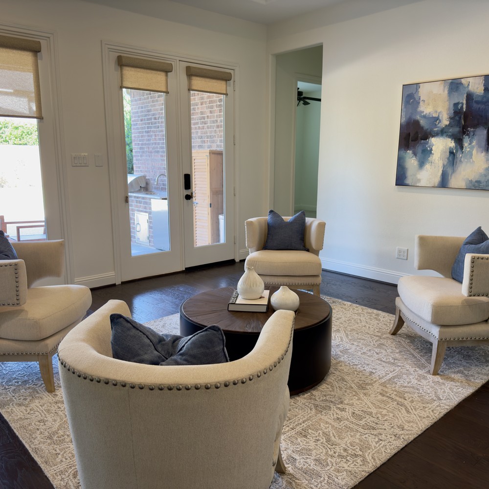The Woodlands Home Staging: Sitting room with four chairs and wooden coffee table.