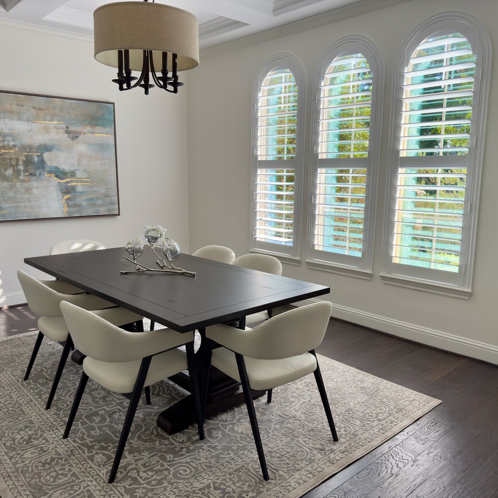 The Woodlands Home Staging: Dining room with black table and six white chairs.