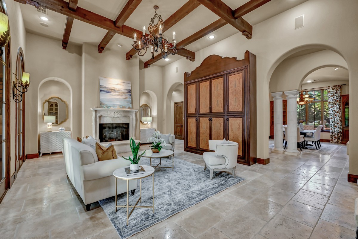 Staging Consultation in Houston, TX. This example living room includes a sofa, two chairs, and a coffee table. This room features extra large ceilings and a gorgeous fireplace.